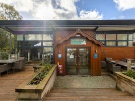 Entrance to The Forest Hub eatery and bar with outdoor seating and wooden planters at Keldy Golden Oak Cottage Keldy Forest