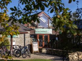 A stone building with bicycles parked outside and a sign reading forest retreat Cropton Golden Oak Cropton Forest