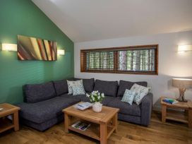 A living room with a sofa and coffee table at Strathyre Golden Oak Lochside in Strathyre, Ben Ledi