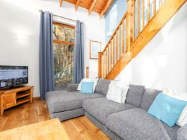 A living room with a sofa and television at Strathyre Classic Silver Birch Strathyre, Ben Ledi