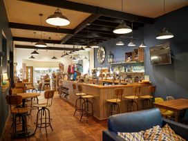 A cafe interior with a bar and seating at Deerpark Classic Golden Oak Waterside Deerpark Forest