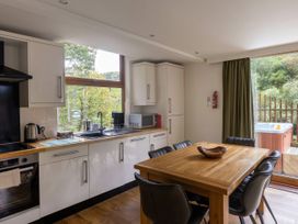 A kitchen with a dining table and chairs at Deerpark Classic Golden Oak Waterside Deerpark Forest