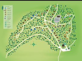 A map showing cabins in a forest with roads play areas bike hire points and electric car charging points at Glentress Forest White Willow Premium Valley View Glentress Forest Peebles