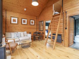 A living room with sofa and dining table at Squirrel's Nest in South Luffenham near Edith Weston