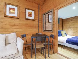 A dining area with a table and chairs at Squirrel's Nest in South Luffenham near Edith Weston