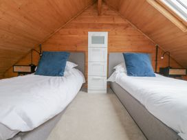 A bedroom with two beds and storage drawers at Squirrel's Nest South Luffenham near Edith Weston