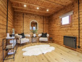 A snug with wooden walls and chairs at Squirrel's Nest in South Luffenham near Edith Weston
