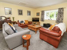 A living room with gray and brown leather sofas wooden coffee table and TV at Millers Cottage in Old Malton near Malton