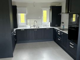 A kitchen with a sink and window at 30 River Run in Belturbet