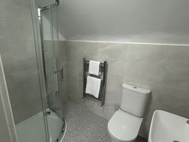 A bathroom with a shower and toilet at 30 River Run in Belturbet
