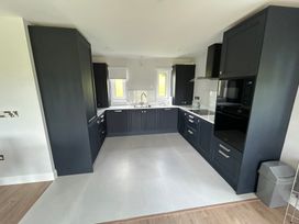 A kitchen with cabinets and appliances at 30 River Run in Belturbet, County Cavan