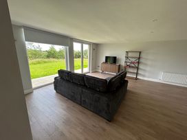 A living room with a sofa and television at 30 River Run, Belturbet, County Cavan