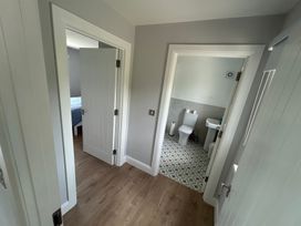 A hallway with doors to a bedroom and a bathroom at 30 River Run, Belturbet, County Cavan