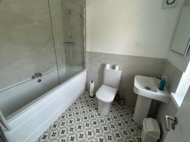 A bathroom with a bathtub, toilet and sink at 30 River Run, Belturbet, County Cavan