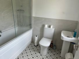 A bathroom with a bathtub, toilet, and sink at 30 River Run, Belturbet, County Cavan