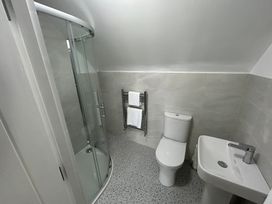 A bathroom with shower, toilet, and sink at 30 River Run, Belturbet, County Cavan