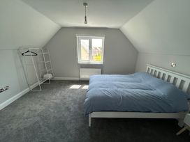 A bedroom with a bed and a clothing rack at 30 River Run, Belturbet, County Cavan