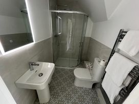 A bathroom with a shower, sink, and toilet at 30 River Run, Belturbet, County Cavan