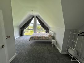 A bedroom with a bed and window at 30 River Run, Belturbet, County Cavan