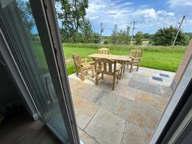 An outdoor patio with wooden furniture at 30 River Run, Belturbet, County Cavan