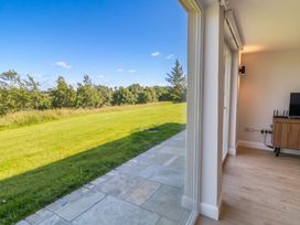A living room with a view of grass and trees at 30 River Run in Belturbet, County Cavan