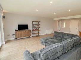 A living room with a sofa and television at 30 River Run, Belturbet, County Cavan
