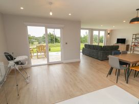 A living room with a sofa and dining table at 30 River Run in Belturbet, County Cavan