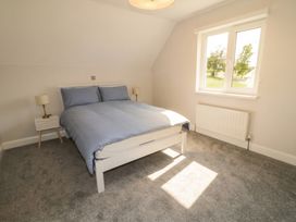 A bedroom with a bed and bedside table at 30 River Run, Belturbet, County Cavan