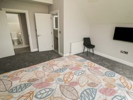 A bedroom with a bed and a chair at 30 River Run, Belturbet, County Cavan