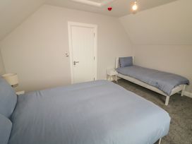 A bedroom with beds and a light fixture at 30 River Run, Belturbet, County Cavan