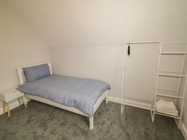 A bedroom with a bed and storage racks at 30 River Run Belturbet, County Cavan