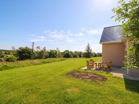 An outdoor area with a table and chairs at 30 River Run in Belturbet, County Cavan