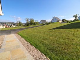 An outdoor area with a pathway leading to houses at 30 River Run, Belturbet, County Cavan