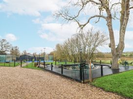 An outdoor area with seating and trees at Otter's View in South Luffenham near Edith Weston