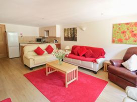A living room with a sofa and coffee table at Heron Cottage