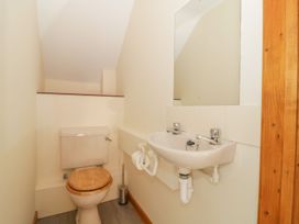 A bathroom with a toilet and sink at Heron Cottage