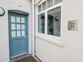 An entrance with a blue door and window at 11 The Craighurst Southwold