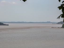 A river landscape with distant buildings at Anvil Cottage in Gatcombe near Blakeney