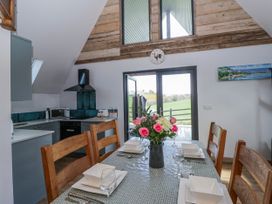 A kitchen with a dining table and chairs at Valley View Hideaway in Ffostrasol