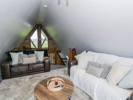 A living room with sofas and a coffee table at Valley View Hideaway in Ffostrasol