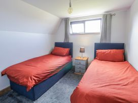 A bedroom with two beds and a nightstand at Valley View Hideaway in Ffostrasol