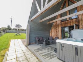 An outdoor area with seating and a hot tub at Valley View Hideaway in Ffostrasol