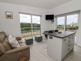 A living room with a sofa and table at Rydlan in Aberystwyth