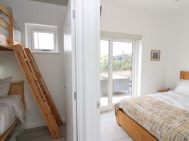 A bedroom with bunk beds and a double bed at Rydlan in Aberystwyth