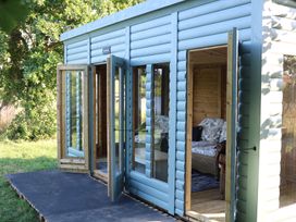 An outdoor structure with seating and large windows at Holmside Audley Brow near Market Drayton