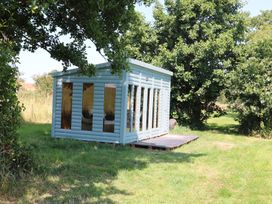 A cabin with large windows and a deck at Holmside Audley Brow near Market Drayton