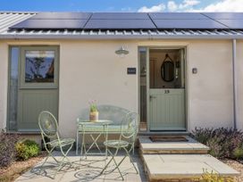 A patio area with a table and chairs at The Little Loft in Burford
