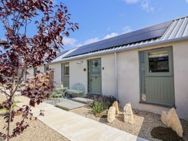 An outdoor area with two doors and solar panels at The Little Loft in Burford
