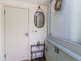 An entryway with a mirror and table at The Little Loft in Burford