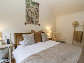 A bedroom with a bed and lamp at The Little Loft in Burford